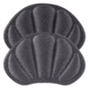 Zwei schwarze, muschelförmige Fersenpolster aus Stoff mit gepolstertem Design
